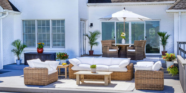 Image of Azza collection wicker sofa and chairs with white cushions on patio